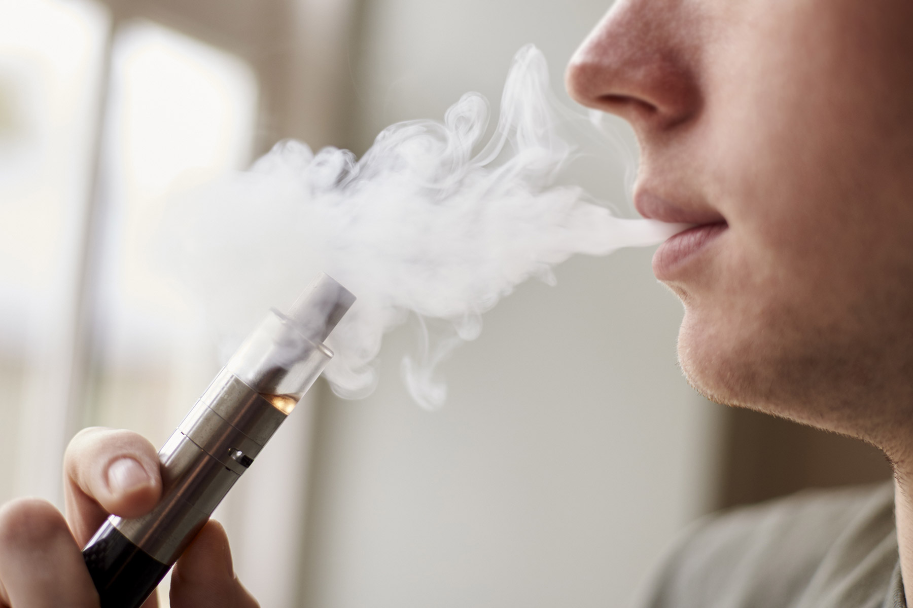 A vape pen being used by a vaper.