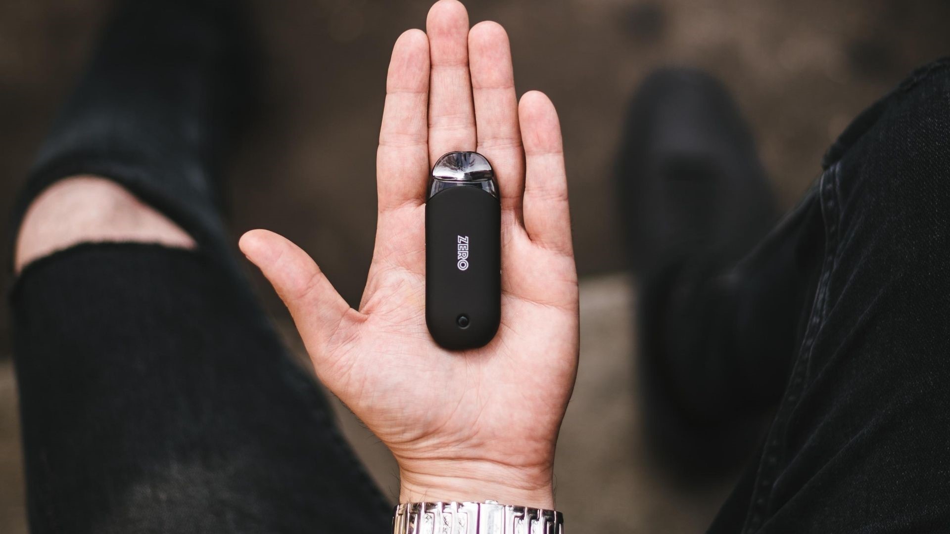A pod vape sitting in someone’s hand.